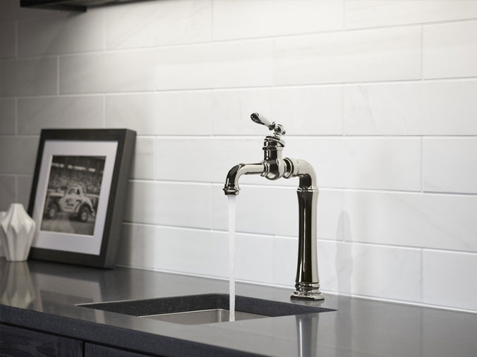 Kitchen faucet on black countertop