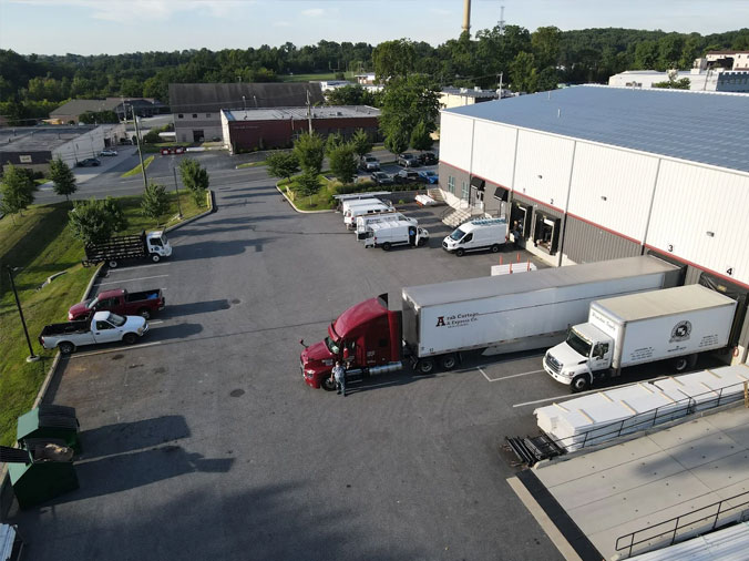 Weinstein Plumbing Supply Broomall PA drone shot of warehouse exterior with trucks